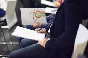 taking notes on business conference photo