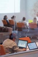 businesswoman using a laptop in startup office photo