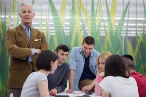 portrait of  teacher with students group in background photo