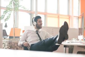 relaxed young business man at office photo