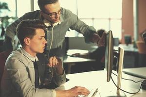 Two Business People Working With computer in office photo