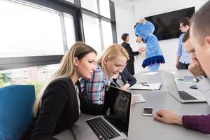 boss dresed as bear having fun with business people in trendy office photo