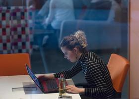 businesswoman using a laptop in startup office photo