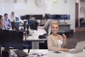 businesswoman using a laptop in startup office photo