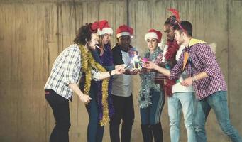 multiethnic group of casual business people lighting a sparkler photo