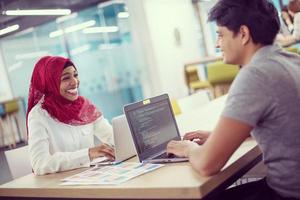 black muslim business woman having a meeting with her indian male colleague photo