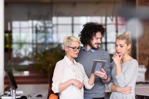 group of Business People Working With Tablet in startup office photo