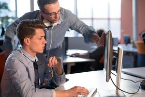 Two Business People Working With computer in office photo