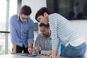 group of Business People Working With Tablet in startup office photo