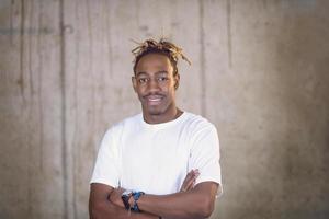 portrait of black businessman in front of a concrete wall photo