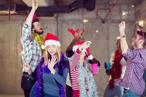 multiethnic group of casual business people dancing with sparklers photo