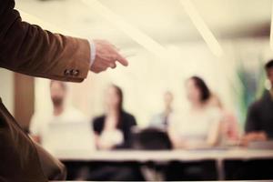 close up of teacher hand while teaching in classroom photo
