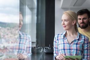 Pretty Businesswoman Using Tablet In Office Building by window photo