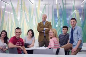 portrait of  teacher with students group in background photo