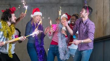 multiethnic group of casual business people dancing with sparklers photo