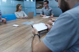 close up of businessman on meeting using tablet photo