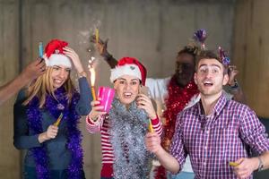 multiethnic group of casual business people dancing with sparklers photo