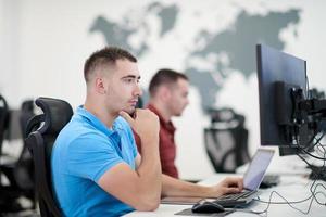 two male software developers working on computer photo