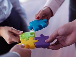 business people group assembling jigsaw puzzle photo