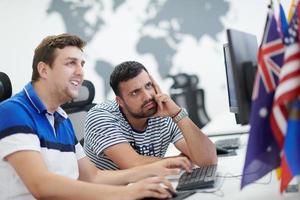 two male software developers working on computer photo
