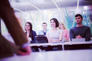 teacher with a group of students in classroom photo