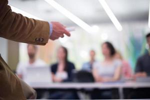 close up of teacher hand while teaching in classroom photo