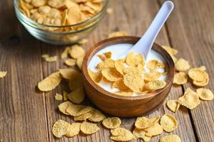 cornflakes bowl breakfast food and snack for healthy food concept, morning breakfast fresh whole grain cereal, cornflakes with milk on table food background photo