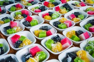 Thai colorful dessert set of in box with classy sweet , black and green coconut shredded pudding , steamed cassava yellow photo