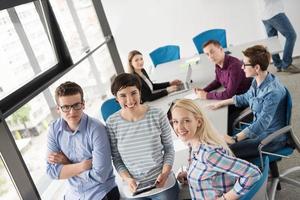 group of Business People Working With Tablet in startup office photo