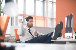 relaxed young business man at office photo