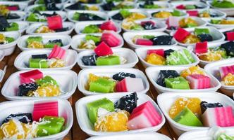 Thai colorful dessert set of in box with classy sweet , black and green coconut shredded pudding , steamed cassava photo