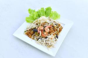 thai style food noodles shrimp and crab stir fried Braised Fish Maw with bean sprouts and egg on white plate photo