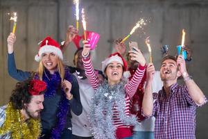multiethnic group of casual business people taking selfie during new year party photo