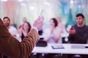 close up of teacher hand while teaching in classroom photo