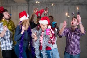 multiethnic group of casual business people dancing with sparklers photo