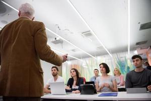 teacher with a group of students in classroom photo