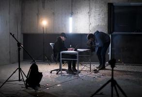 videographer recording talented hacker while working in dark office photo