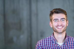 portrait of casual businessman in front of a concrete wall photo