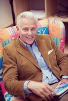 portrait of handsome teacher in colorful chair photo