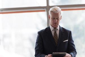 senior business man working on tablet computer photo