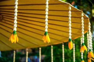 Wooden frame handmade umbrella with mulberry paper decorated with jasmine garland photo