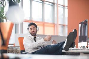 relaxed young business man at office photo