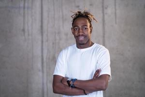 portrait of black businessman in front of a concrete wall photo