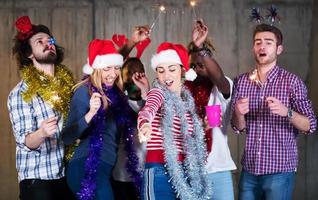 multiethnic group of casual business people dancing with sparklers photo