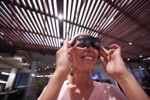 woman using virtual reality gadget computer glasses photo