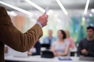close up of teacher hand while teaching in classroom photo