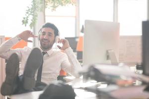 relaxed young business man at office photo