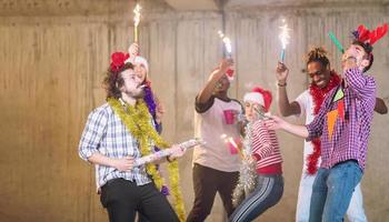 multiethnic group of casual business people dancing with sparklers photo