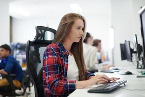 casual business woman working on desktop computer photo