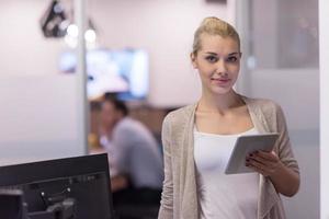 Business Woman Using Digital Tablet in front of startup Office photo